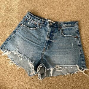 Abercrombie 90’s relaxed cutoff short in high rise. Medium wash with distressing